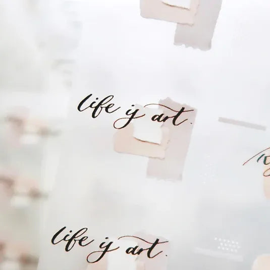 Latte PET Tape life is art phrase styled on a white pillow against a softly blurred background