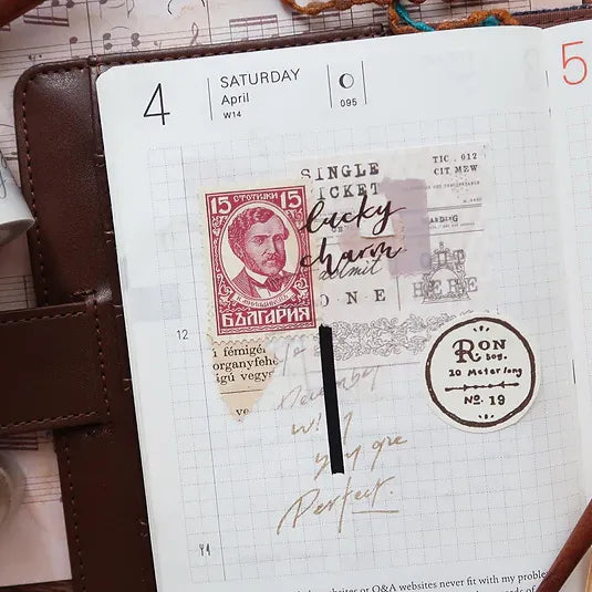 Journal page styled with Latte PET Tape vintage-style stamp designs, overhead journaling flat lay