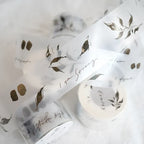 White ribbon with gold leaf and text design on a white background