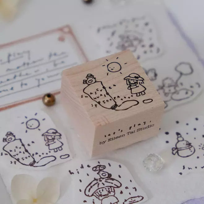 Let's Play Sunny Day stamp with stamped images and stationery items styled around it