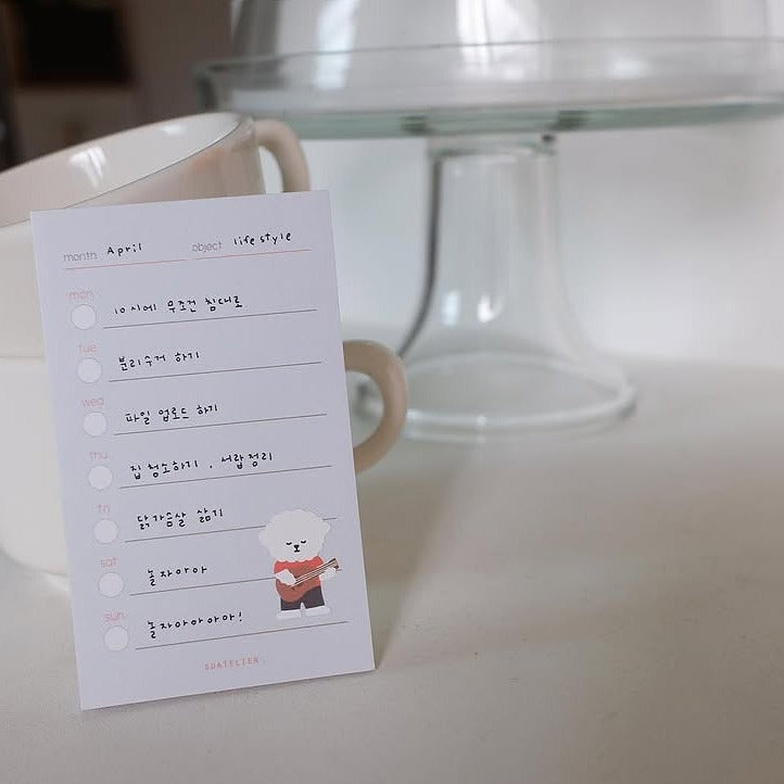 Notepad with a checklist and bear illustration beside a mug, from the Let's go Camping Sticker Sheet