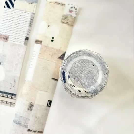 Rolls of Letter Washi Tape with a clear container labeled Letter on a white surface