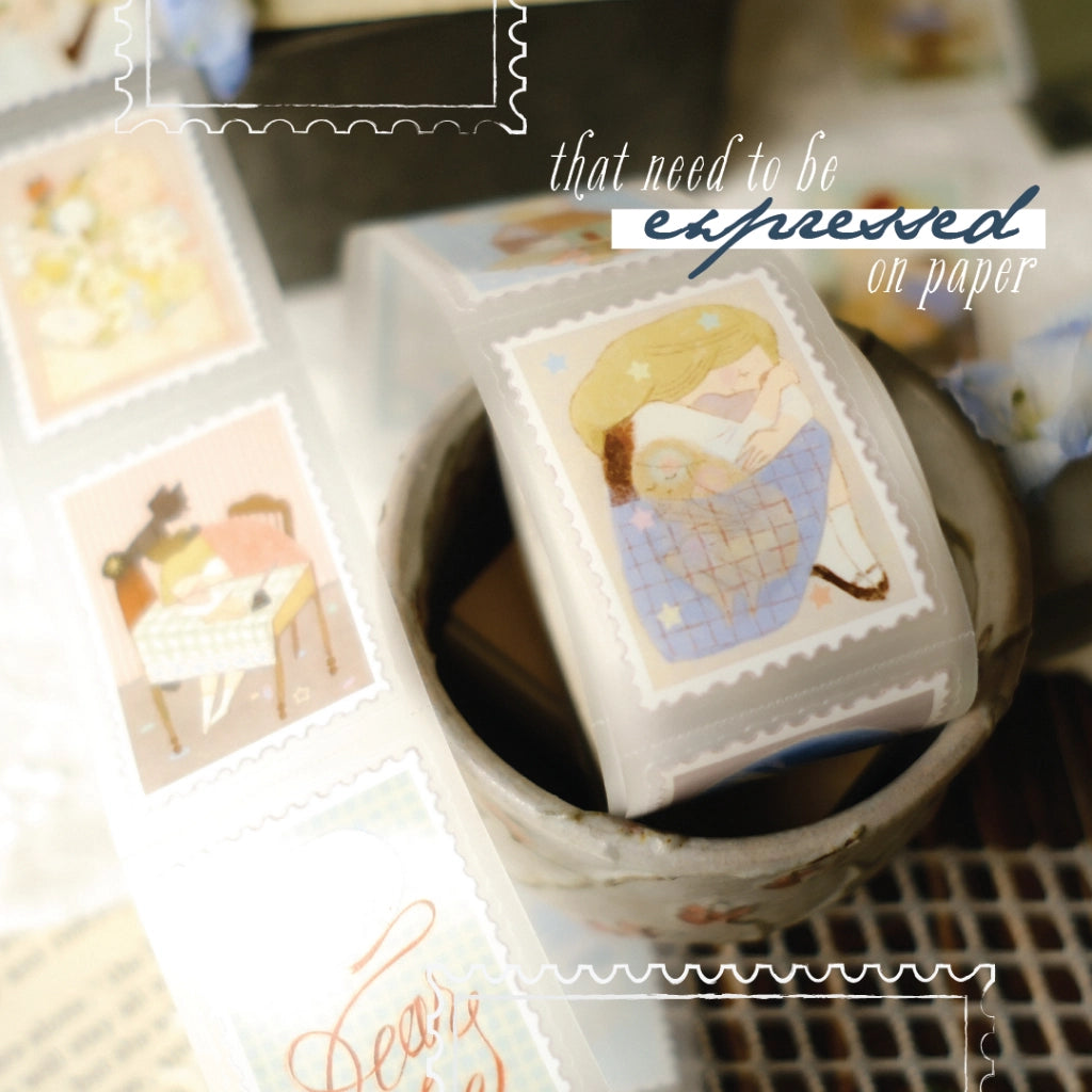 Decorative rubber stamps with illustrations in a container on a textured surface.