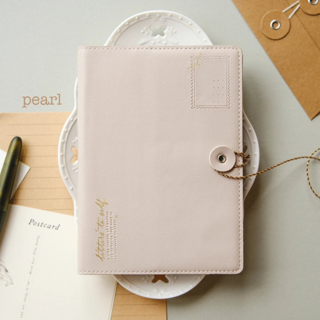 Pink notebook with decorative elements on a light background