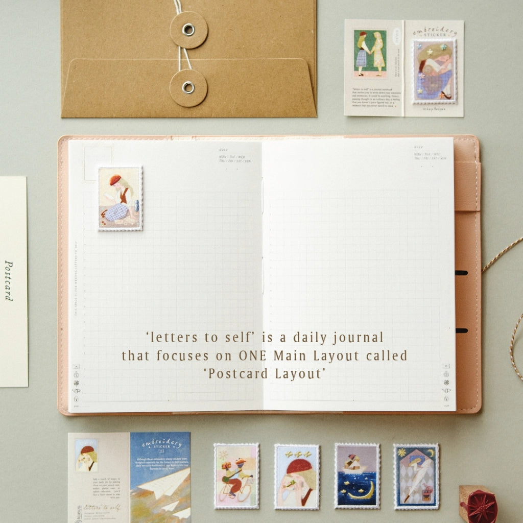 Open daily journal with postcard layout on a light gray background