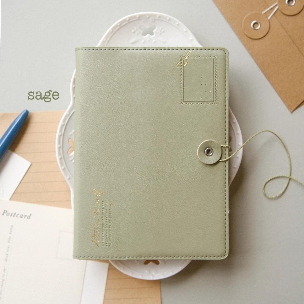 Green notebook with decorative elements on a light background