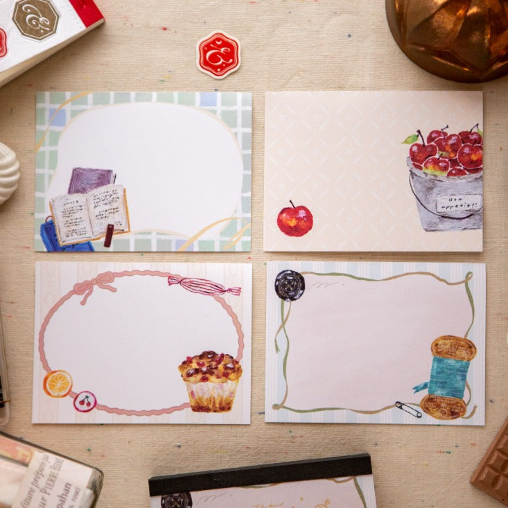 Set of illustrated cards on a wooden surface with stationery items.
