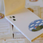 White board with colorful designs on a wooden surface