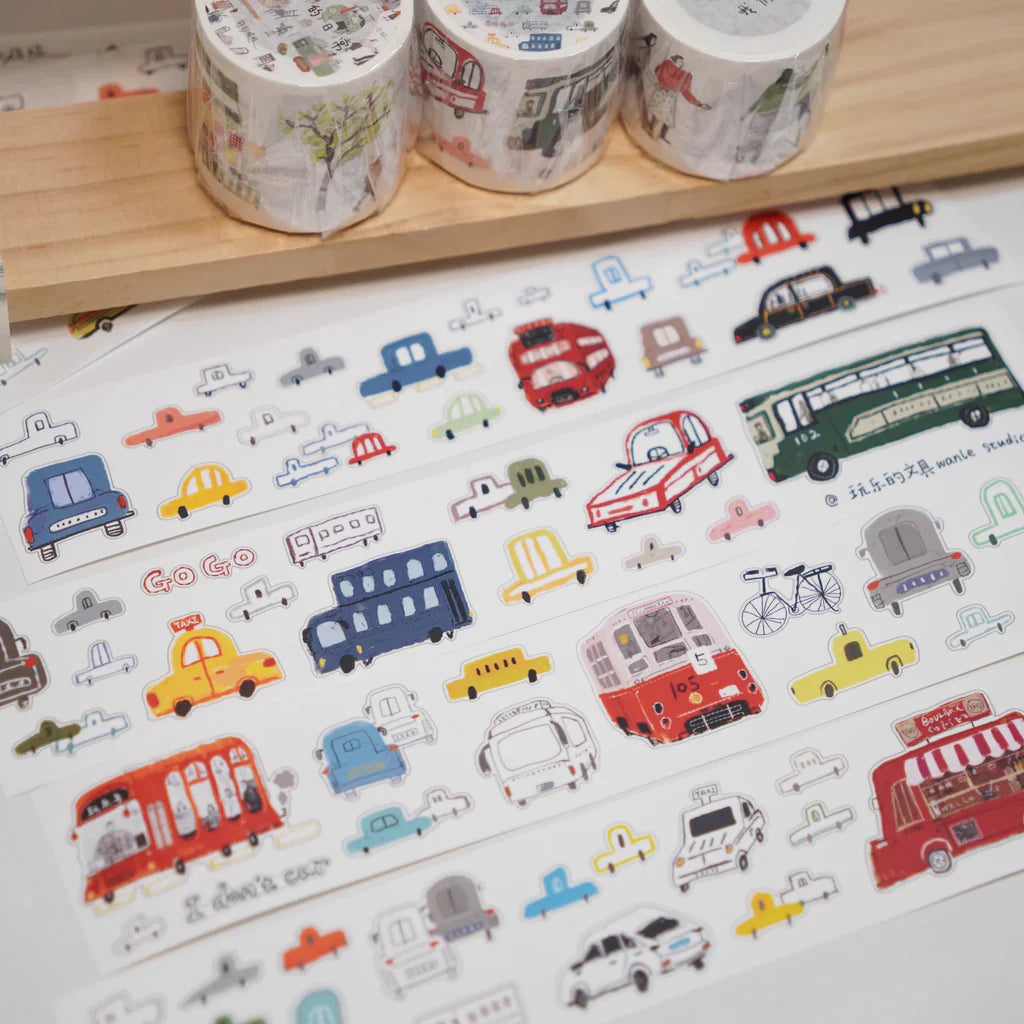 Colorful rolls of Lots of Cars Sticker Tape with vehicle designs on a white surface