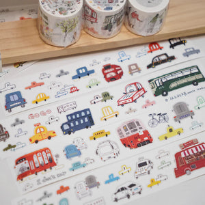 Colorful rolls of Lots of Cars Sticker Tape with vehicle designs on a white surface