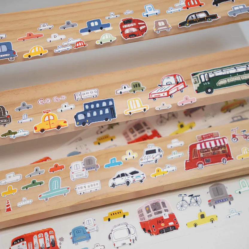 Wooden toy decorated with colorful Lots of Cars Sticker Tape vehicles on a white backdrop