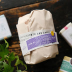 Package with a label on a wooden surface with plants