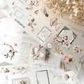 Collection of floral and vintage-style stationery items on a textured surface.