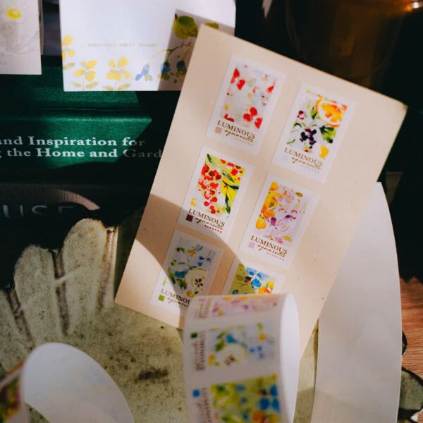Luminous Label Sticker Tape florals styled on a white envelope, softly blurred backdrop