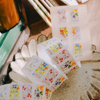 Floral stickers on a white surface with a blurred background