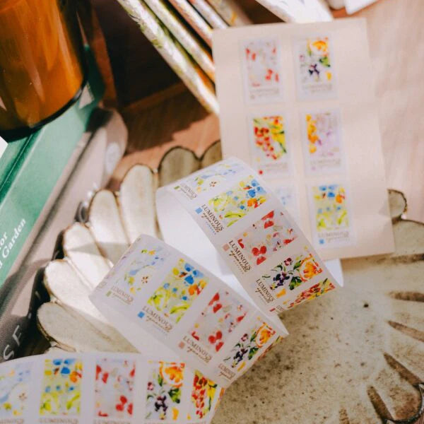 Floral stickers on a white surface with a blurred background