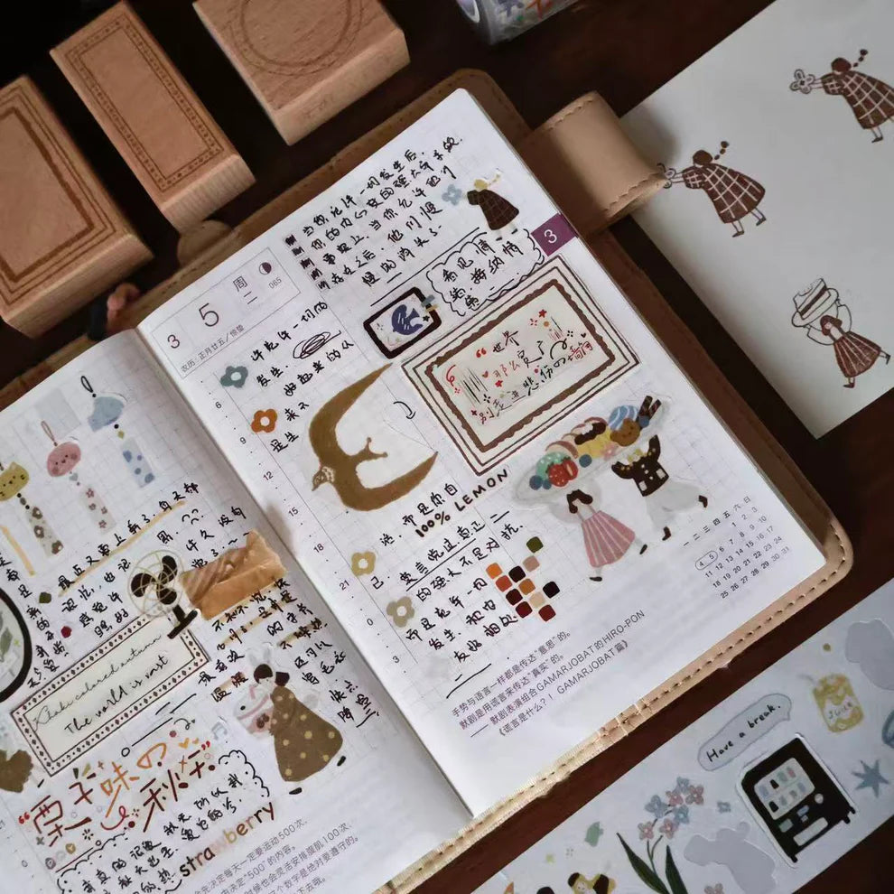 Open book styled with Macaron Afternoon PET Tape illustrated pages and text on wood