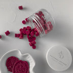 Pink wax seals in a clear container on a white surface with 'Auvanna Decors' branding.