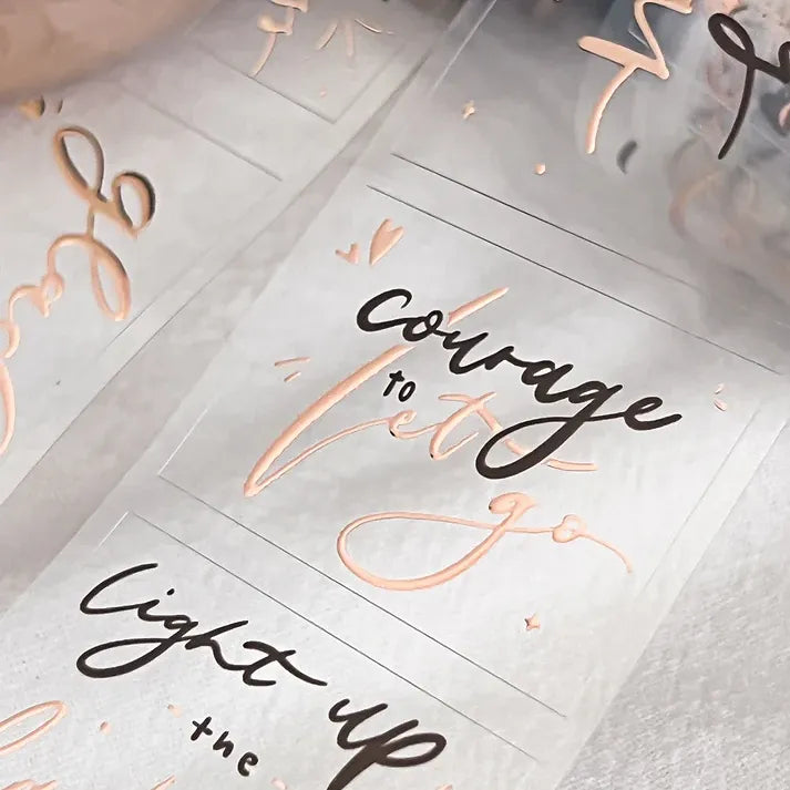 Motivational phrases on a textured surface with rose gold accents