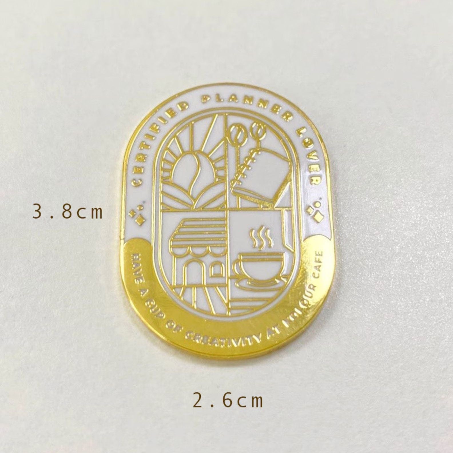 Gold and white emblem with measurements on a light gray background