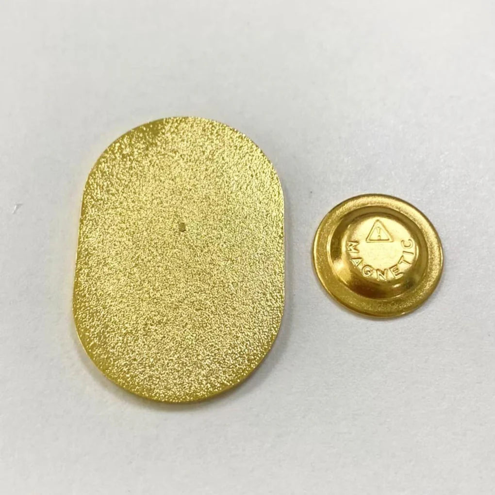 Gold magnetic backing pieces of the Planner Lover Badge Charm showing plate and round magnet