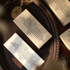 Two rectangular cards with grid patterns on a dark surface