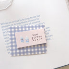 Earring card with water bottle illustrations on a checkered background