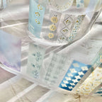 Set of washi tape rolls with floral designs on a marble surface