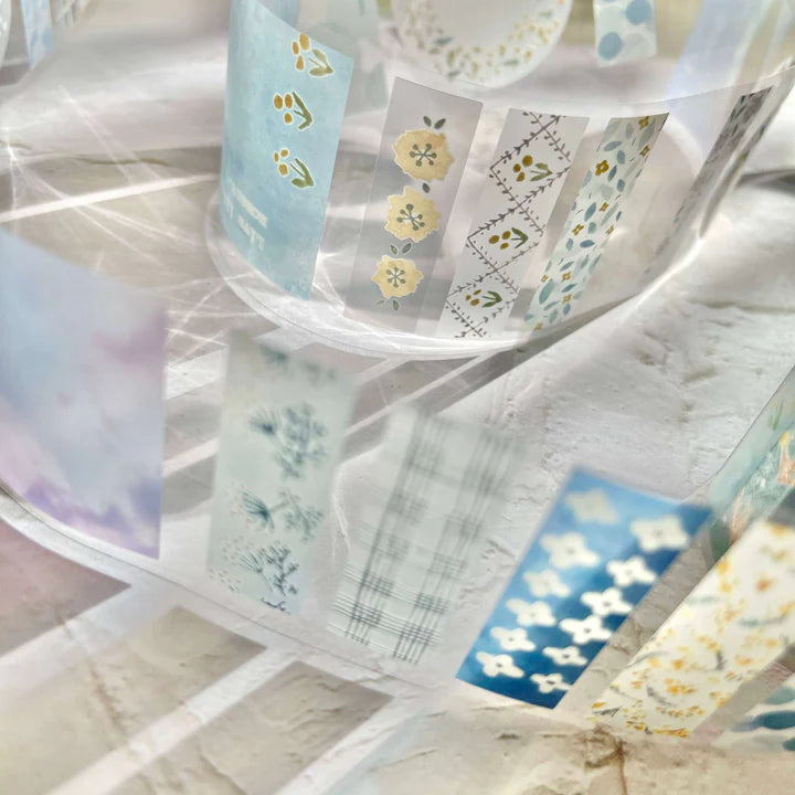 Set of Meet You PET Tape rolls with floral designs displayed together on a marble surface