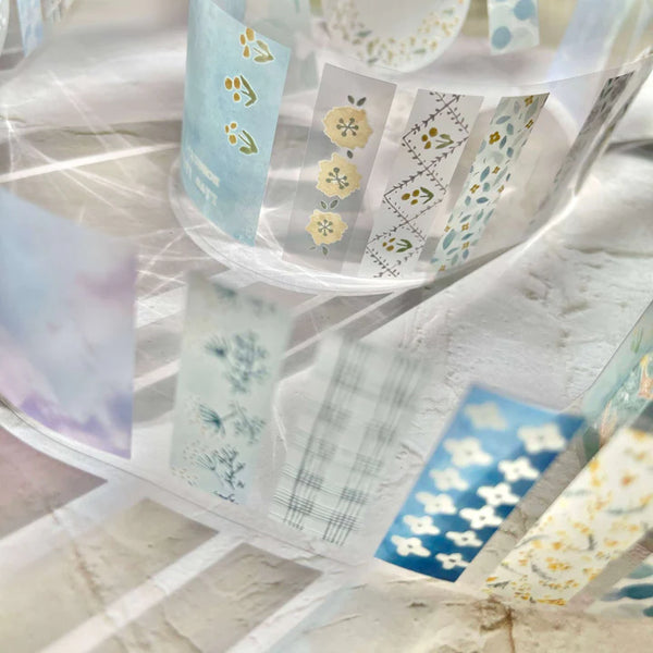 Set of Meet You PET Tape rolls with floral designs displayed together on a marble surface