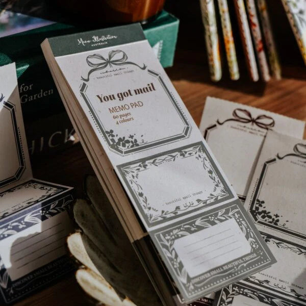 Memo pad with decorative design and text on a wooden surface