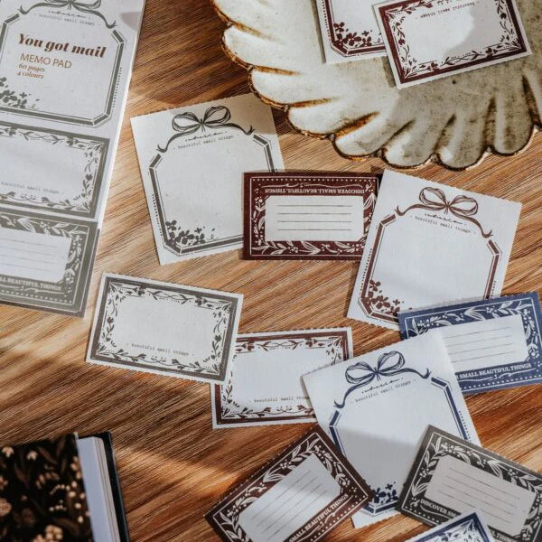 You Got Mail Memo Pad bordered letter sheets arranged on a wooden surface, flat lay