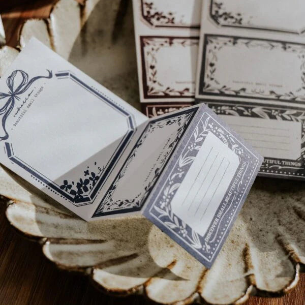 You Got Mail Memo Pad sheets with intricate mail-inspired designs on a textured surface