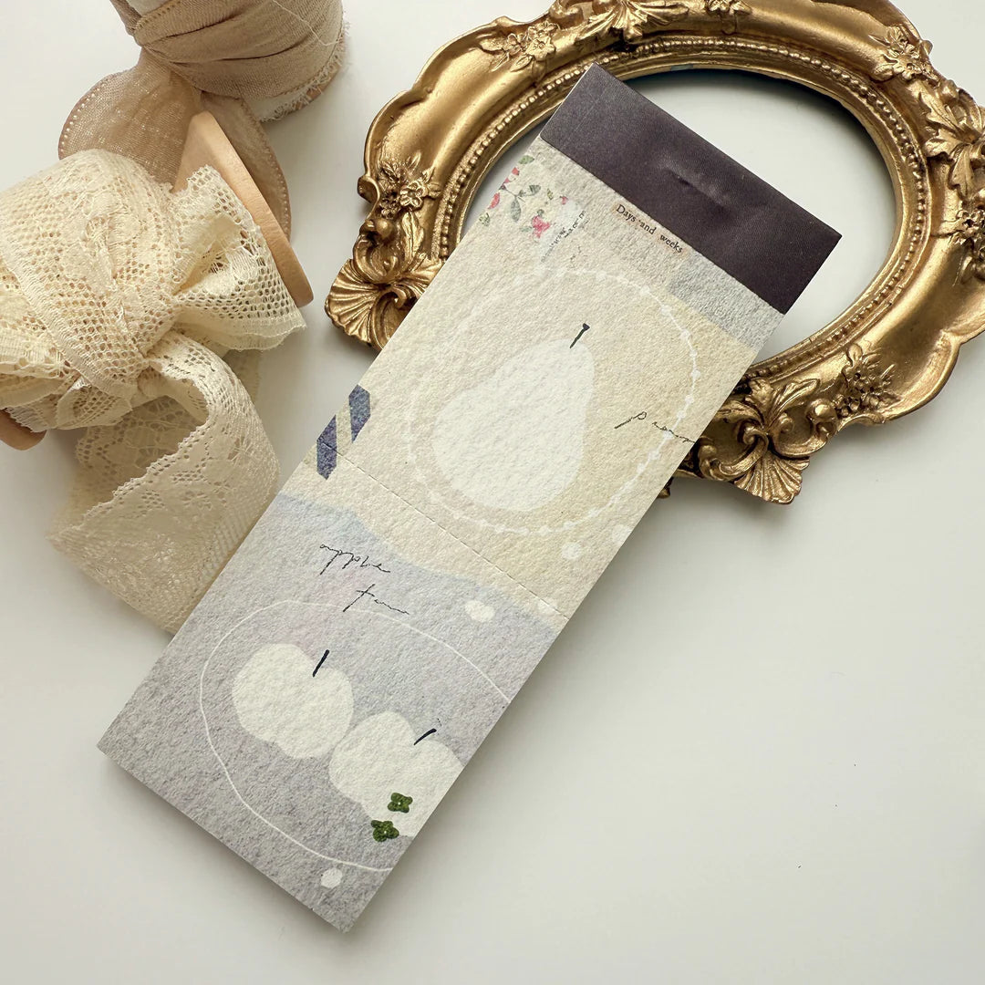 Pack of socks with apple design on a white surface with decorative elements