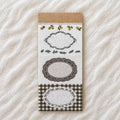 Decorative paper with printed frames on a textured white surface