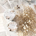 Two containers labeled 'crea with gaby' on a surface with dried flowers.