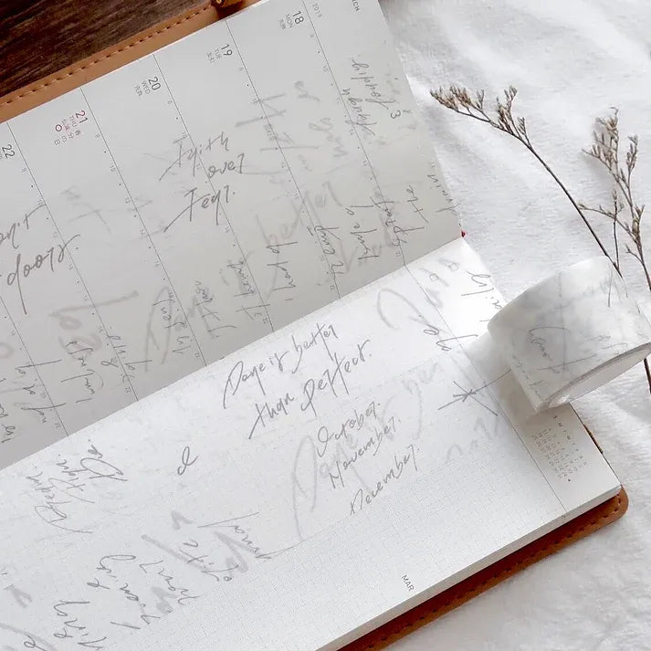 Open notebook with handwritten notes styled with Messy Messy Washi Tape and dried flowers on white