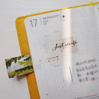 Journal with a yellow ribbon and text 'Just create' on a white background