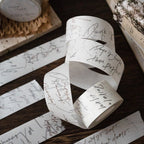 Roll of paper with handwritten text on a wooden surface