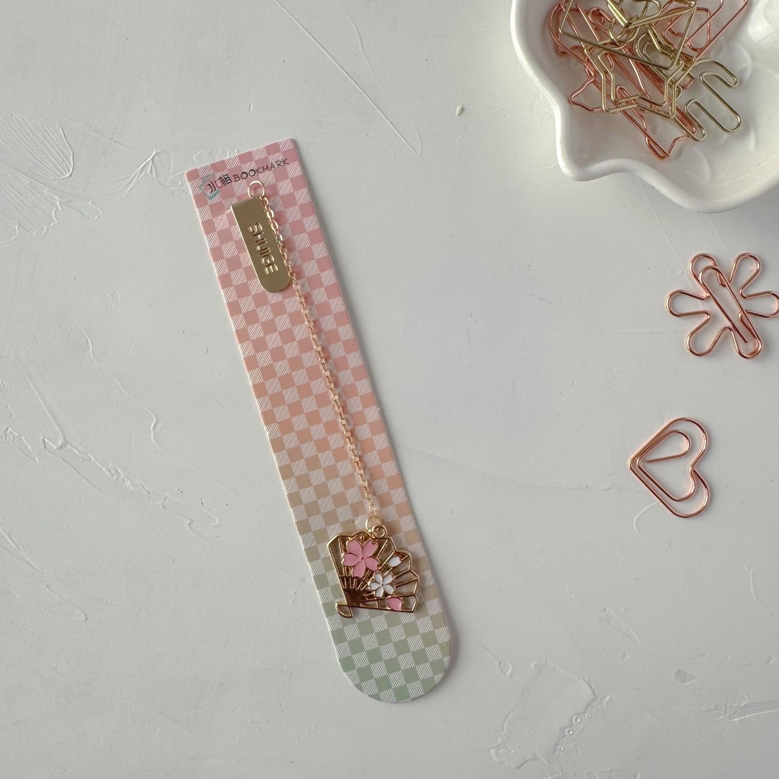 Decorative paper clips on a checkered strip with a white background