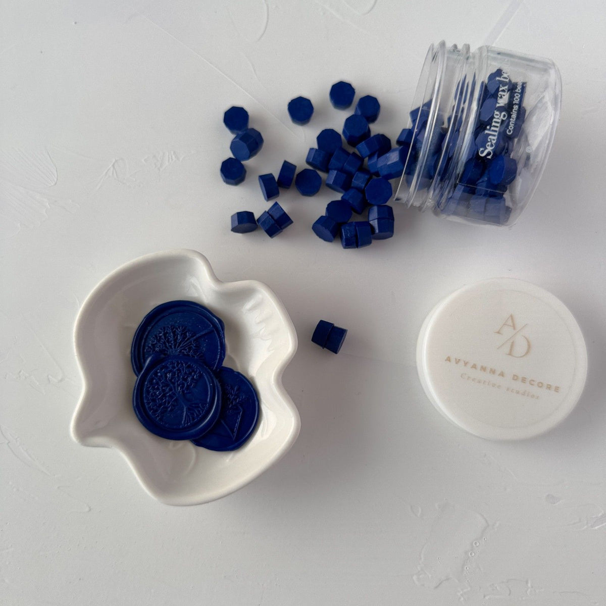Deep Midnight Blue Wax Beads and melted wax seals styled in a dish on a white branded studio backdrop
