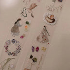 Collage of paper cutouts of people, jewelry, and flowers on a textured beige background