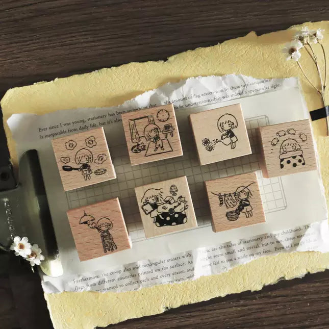 Mini Girls At Home Rubber Stamp set with cozy home-life cartoon designs on a wooden surface