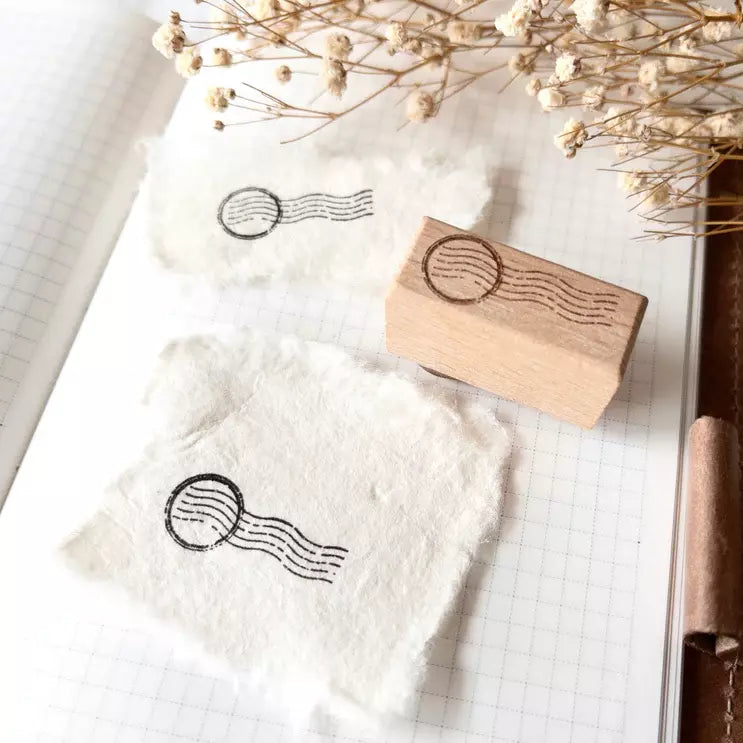 Mini Postal I Rubber Stamp postage design displayed on a white fabric background, close-up