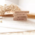 Stack of wooden blocks with engraved quotes on a soft background