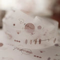 Close-up of a decorative box with artistic text and patterns on a blurred background