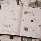 Open notebook with decorative pages and text on a textured surface
