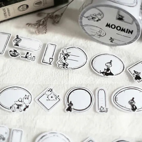 Moomin Label Sticker Tape with black and white Moomin character labels on a textured surface