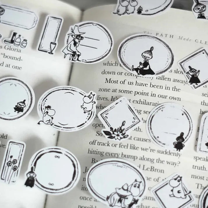 Moomin Label Sticker Tape black and white character illustrations styled across an open book page