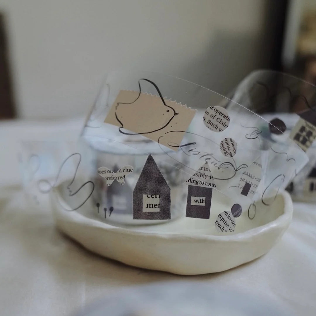 Homecoming Bird PET Tape paper cutouts styled in a glass bowl on a marble surface